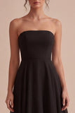 Strapless A-lijn midi black tie jurk